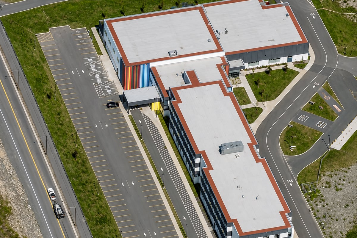 Paradise Intermediate School — aerial view of the completed school, gymnasium block and parking